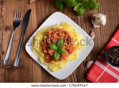 tagliatelle with cheese sauce garnished with basil leaves
