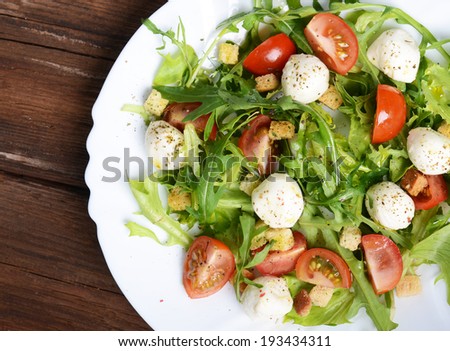Greece salad with mozzarella, ruccola and tomatoes