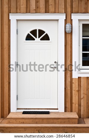 white front door in a wooden building