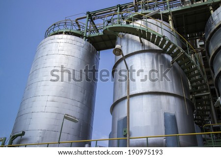 Chemical storage tank in clear sky.