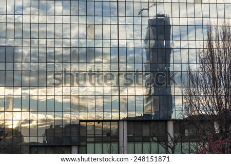 MILAN, ITALY - DECEMBER 18, 2014: Citylife, modern residential and business buildings in Milan (Lombardy, Italy). Sunset reflected