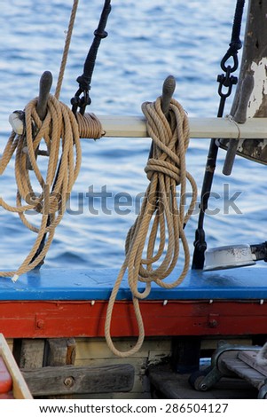 Two ropes are attached to a sail of the sailing boat