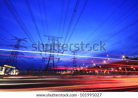 Large city road night  and transmission tower scene, long exposure night car rainbow light trails