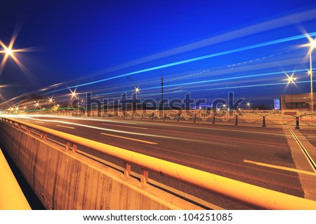 Urban focus of a major highway viaduct with light trails night landscape