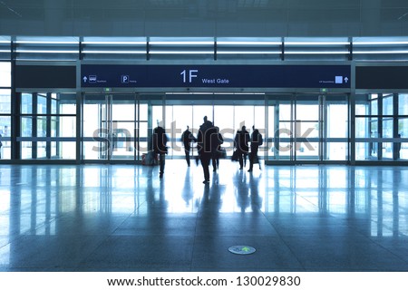 Passengers in a hurry to walk the modern airport interior gate