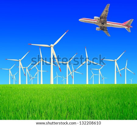 Aircraft is flying in the environmentally friendly power generation wind turbines in the rice farms at concept