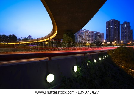 high-speed urban viaduct construction night view car light trails