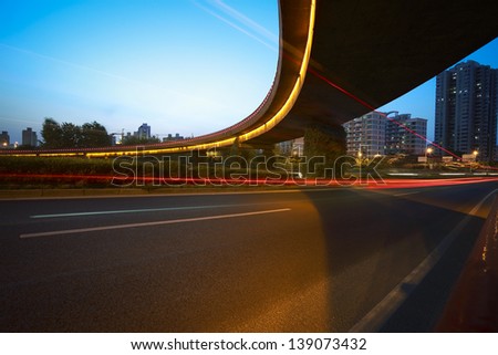 high-speed urban viaduct construction night view car light trails