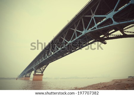 Looking up blue steel bridge across the water