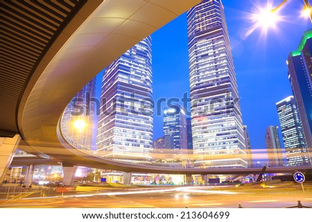 The highway bridge car light trails of shanghai city modern office buildings