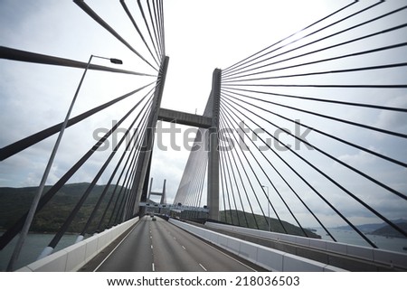 On the left side of the highway driving route at Bottom looking up of modern cable-stayed bridge