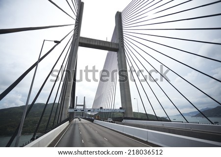 On the left side of the highway driving route at Bottom looking up of modern cable-stayed bridge