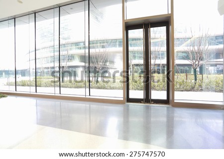 The new bright empty office building glass door