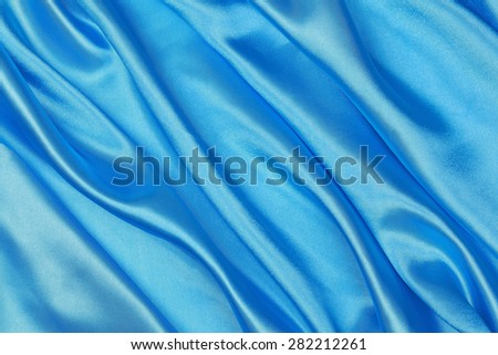 Blue and red Silk cloth of abstract background or wavy folds or satiny silk texture satin velvet material or elegant wallpaper design curve.