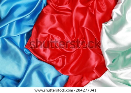 Blue and red and light green silk texture satin velvet material or elegant wallpaper design curve backgrounds