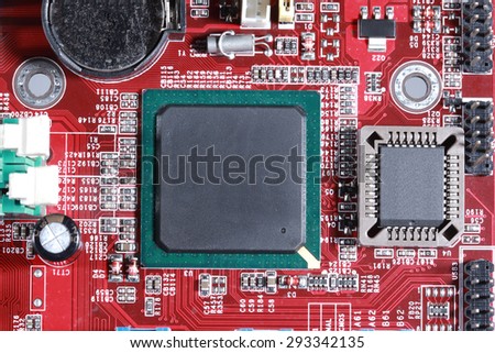 Close-up of red electronic motherboard circuit board with processor