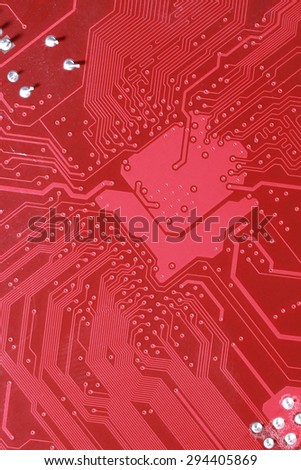 Red circuit board texture background close-up of computer motherboard