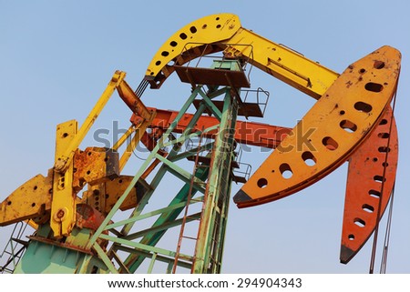 Golden yellow and orange Oil pump oil rig energy industrial machine for petroleum crude
