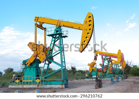Under sunny golden yellow and pink Oil pump oil rig energy industrial machine for petroleum crude