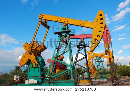 Under sunny golden yellow and pink Oil pump oil rig energy industrial machine for petroleum crude