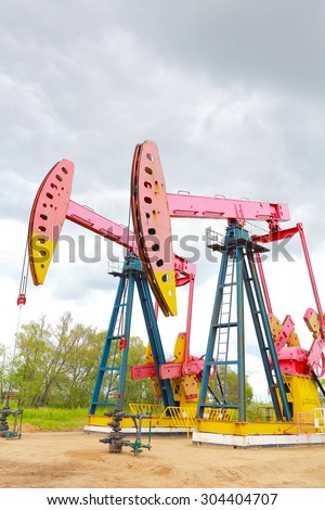 Pink Oil pump oil rig energy industrial machine for petroleum crude of countryside dirt road