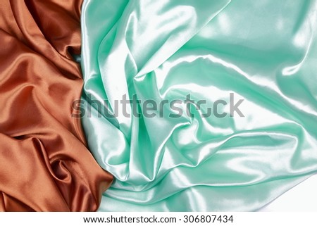 Brown and light green silk texture satin velvet material or elegant wallpaper design curve folds wavy background