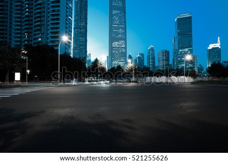 Empty road floor surface with modern city landmark buildings of night scene in Shanghai
