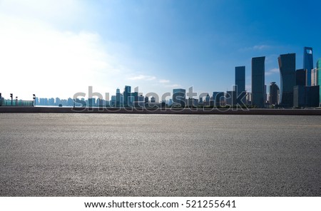 Empty road floor surface with modern city landmark buildings of Shanghai bund Skyline