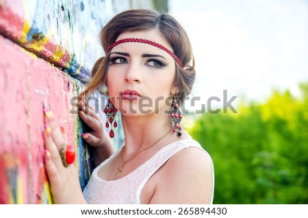 woman standing next to a wall in summer day