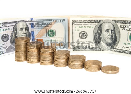 Lot of golden coins in rising price graph or bar chart  with  US currency one hundred dollar bills