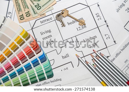 Closeup plan home with a palette of colors, pencils, keys and dollar