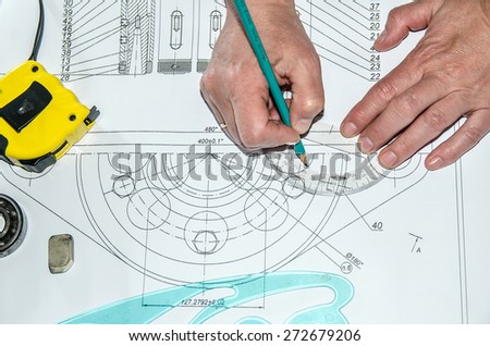 Abstract technical drawings. Mechanical engineer at work.  Pencil, calculator, line and hand man. Paper with technical drawings