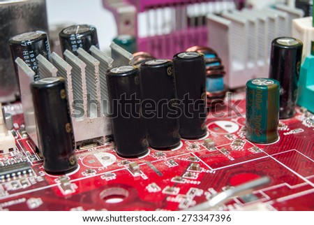 red computer motherboard with electrical components