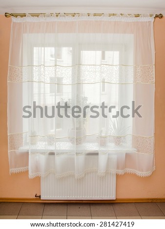 elegant light curtains (tulle) on the window in the kitchen