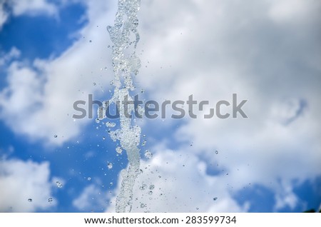 Water droplets against blue sky