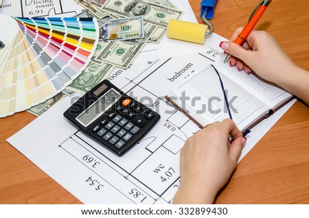Architect\'s work space during work with technical drawing and color samples, dollar, notepad, calculator