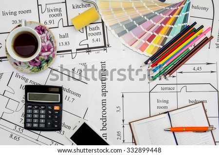 colorful paint samples on house plan  with pencil, notebook, tea as background