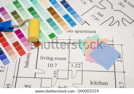 paintbrushes and color palette over the house plan