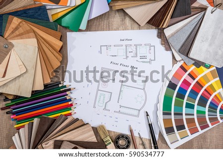 Drawing plan house with a palette of colors on wooden background