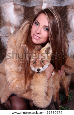 Attractive woman in fur coat with fox