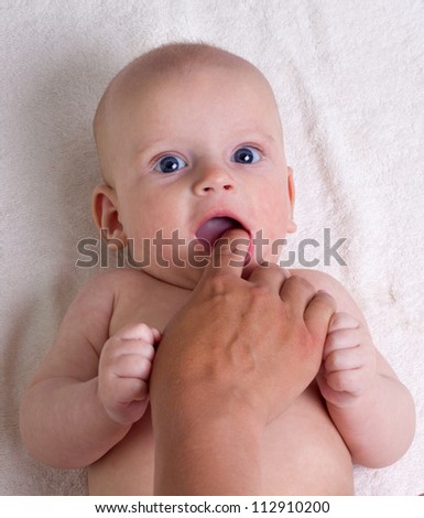 Teething baby biting fingers