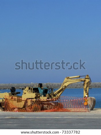 Digger at Construction Site in a Sea Port