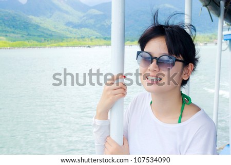 beautiful young woman smile in ship on the sea, thailand