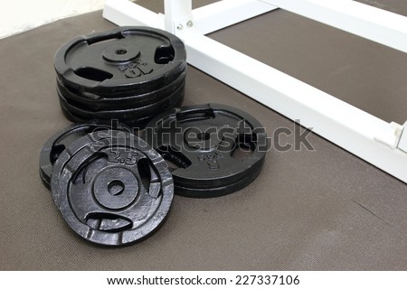 Barbells weight plate in gym room