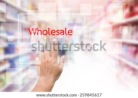 Hand Clicking On Wholesale Screen With Supermarket Shelves Blurred Background