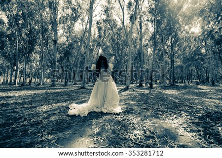 Mysterious Woman in White Dress in the Forest,Scary Woman in the Wood,Horror Background For Halloween Concept and Book Cover Ideas