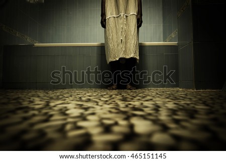 Scary person in white dress standing close to bathtub,Scary background for book cover