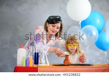 Crazy professor conducting chemical experiments in the company of a little girl.