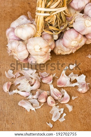 garlic on brown textured wood.It is a herb.
