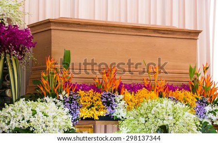 Religion, death and dolor - funeral and cemetery; funeral with coffin with flowers